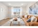 Bright and airy living room with large window, white walls, and neutral tones creating a comfortable atmosphere at 1805 W 51St Ave, Denver, CO 80221