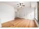 Bright bedroom featuring hardwood floors, an exposed brick wall, and multiple closets at 1210 E Colfax Ave # 301, Denver, CO 80218