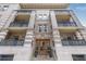 A stunning view of the apartment building with ornate architecture and balconies at 1210 E Colfax Ave # 301, Denver, CO 80218