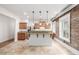 Bright kitchen with granite counters, stainless steel appliances, and a breakfast bar, complemented by an exposed brick wall at 1210 E Colfax Ave # 301, Denver, CO 80218