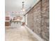 Open-concept kitchen featuring an exposed brick wall, stainless steel appliances, and a granite-topped breakfast bar at 1210 E Colfax Ave # 301, Denver, CO 80218