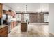 Spacious kitchen area featuring granite countertops, stainless steel appliances, exposed brick, and tile floors at 1210 E Colfax Ave # 301, Denver, CO 80218