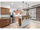 Stylish kitchen featuring granite counters, stainless steel appliances, exposed brick, and a convenient breakfast bar area at 1210 E Colfax Ave # 301, Denver, CO 80218