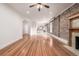 Open living space featuring wood floors, exposed brick, fireplace, and an adjoining room visible at 1210 E Colfax Ave # 301, Denver, CO 80218