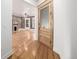 Inviting space with a fireplace, hardwood floors, and a doorway with glass panel at 1210 E Colfax Ave # 301, Denver, CO 80218