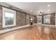 Spacious living room with exposed brick accent wall, fireplace and beautiful hardwood floors at 1210 E Colfax Ave # 301, Denver, CO 80218