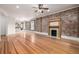 Open-concept living space boasting hardwood floors, a fireplace, and views into the kitchen area at 1210 E Colfax Ave # 301, Denver, CO 80218