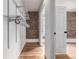 Spacious walk-in closet with metal shelving, hardwood floors, and exposed brick walls, offering ample storage at 1210 E Colfax Ave # 301, Denver, CO 80218