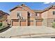 Townhome with garages and driveway in front, featuring stone accents and a well-maintained exterior at 23525 E Platte Dr # 10B, Aurora, CO 80016