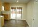 Dining area with wood floors, sliding glass door, and access to the patio at 3825 E 123Rd Ave, Thornton, CO 80241