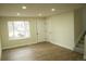 Bright, freshly painted living room featuring wood floors and lots of natural light at 3825 E 123Rd Ave, Thornton, CO 80241