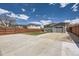 Spacious backyard with a large concrete parking area and a wooden fence at 3227 N Steele St, Denver, CO 80205