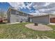 Landscaped backyard with a fire pit and a large grassy area at 3227 N Steele St, Denver, CO 80205
