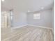 Spacious basement bedroom with light grey walls and vinyl wood flooring at 3227 N Steele St, Denver, CO 80205