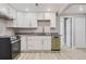 Modern basement kitchen featuring white cabinets, granite countertops, and stainless steel appliances at 3227 N Steele St, Denver, CO 80205