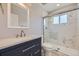 Modern bathroom with a large walk-in shower and dark vanity at 3227 N Steele St, Denver, CO 80205