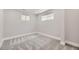 Bright bedroom with light gray walls and gray carpeting at 3227 N Steele St, Denver, CO 80205