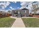 Gray brick home with a landscaped yard, walkway, and modern wooden fence at 3227 N Steele St, Denver, CO 80205