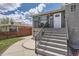 Modern home exterior with gray brick, a walkway and stairs leading to the front door at 3227 N Steele St, Denver, CO 80205