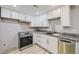Modern kitchen with white cabinets and granite countertops at 3227 N Steele St, Denver, CO 80205