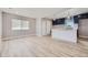 Open concept living room and kitchen with wood-look flooring at 3227 N Steele St, Denver, CO 80205