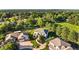 Aerial perspective of a beautiful home showcasing the front yard and surrounding mature trees, located in a quiet neighborhood at 5284 Taft Ct, Arvada, CO 80002