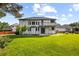 Expansive backyard featuring a lush lawn, mature trees, and a spacious deck perfect for outdoor entertaining at 5284 Taft Ct, Arvada, CO 80002