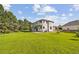 Rear exterior view of the house showcases a large lawn and a deck that overlooks the area at 5284 Taft Ct, Arvada, CO 80002