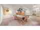 Basement area with a pool table, bar, dart board, and view into an adjacent bedroom at 5284 Taft Ct, Arvada, CO 80002