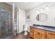 Bathroom with a slate tile shower, wood cabinet vanity, and a textured wall at 5284 Taft Ct, Arvada, CO 80002