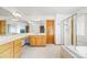 Well-lit bathroom featuring a glass-enclosed shower, tub, and vanity area at 5284 Taft Ct, Arvada, CO 80002