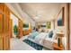 Spacious main bedroom boasts natural light, elegant decor, and sitting area near the fireplace at 5284 Taft Ct, Arvada, CO 80002
