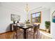 Bright dining room offers a chandelier, a wooden table with seating for six, and a large window at 5284 Taft Ct, Arvada, CO 80002