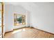 Bright, empty room features a large bay window, hardwood floors, and neutral walls, ideal for customization at 5284 Taft Ct, Arvada, CO 80002