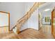 Spacious foyer showcases hardwood floors and a staircase with wood railings, perfect for a grand entrance at 5284 Taft Ct, Arvada, CO 80002