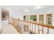 Upstairs hallway boasts wood railing with views to the floor below and lots of windows for natural light at 5284 Taft Ct, Arvada, CO 80002