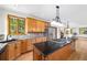 Kitchen boasts granite counters and light wood cabinets, stainless steel appliances, and an island with a gas cooktop at 5284 Taft Ct, Arvada, CO 80002