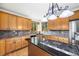 Kitchen boasts granite counters, light wood cabinets, stainless steel appliances, and a gas range cooktop at 5284 Taft Ct, Arvada, CO 80002
