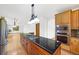 Kitchen features an island with granite counters and a gas cooktop, stainless steel appliances, and wood cabinets at 5284 Taft Ct, Arvada, CO 80002