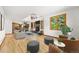 Open-concept living room and kitchen area with a fireplace, large windows, and hardwood floors at 5284 Taft Ct, Arvada, CO 80002