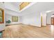 Spacious living room with light hardwood floors and white walls with windows around the room at 5284 Taft Ct, Arvada, CO 80002