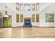 Bright living room boasts a fireplace, light hardwood floors, and many windows that let in natural light at 5284 Taft Ct, Arvada, CO 80002