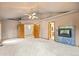 Spacious living room featuring a fireplace, neutral decor, and multiple entryways at 5284 Taft Ct, Arvada, CO 80002