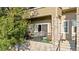 A cozy balcony with stone accents featuring a table and chairs at 11250 Florence St # 5C, Commerce City, CO 80640