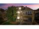 An exterior view of this brown townhouse shows the multi-level porches and lush landscaping at 11250 Florence St # 5C, Commerce City, CO 80640