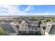 An aerial view shows the townhouse exteriors, rooflines, and attached garages at 11250 Florence St # 5C, Commerce City, CO 80640