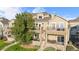 Beautiful tan townhome featuring multiple balconies and stone accents at 11250 Florence St # 5C, Commerce City, CO 80640