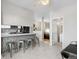 Modern eat-in kitchen featuring an island with bar stools, white cabinets and stainless steel appliances at 11250 Florence St # 5C, Commerce City, CO 80640