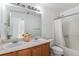 Bathroom with double sinks, a large mirror, and a shower-tub combination at 21093 E 53Rd Ave, Denver, CO 80249