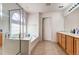 Bright bathroom featuring walk-in shower, tub and double vanity with wood cabinets at 21093 E 53Rd Ave, Denver, CO 80249